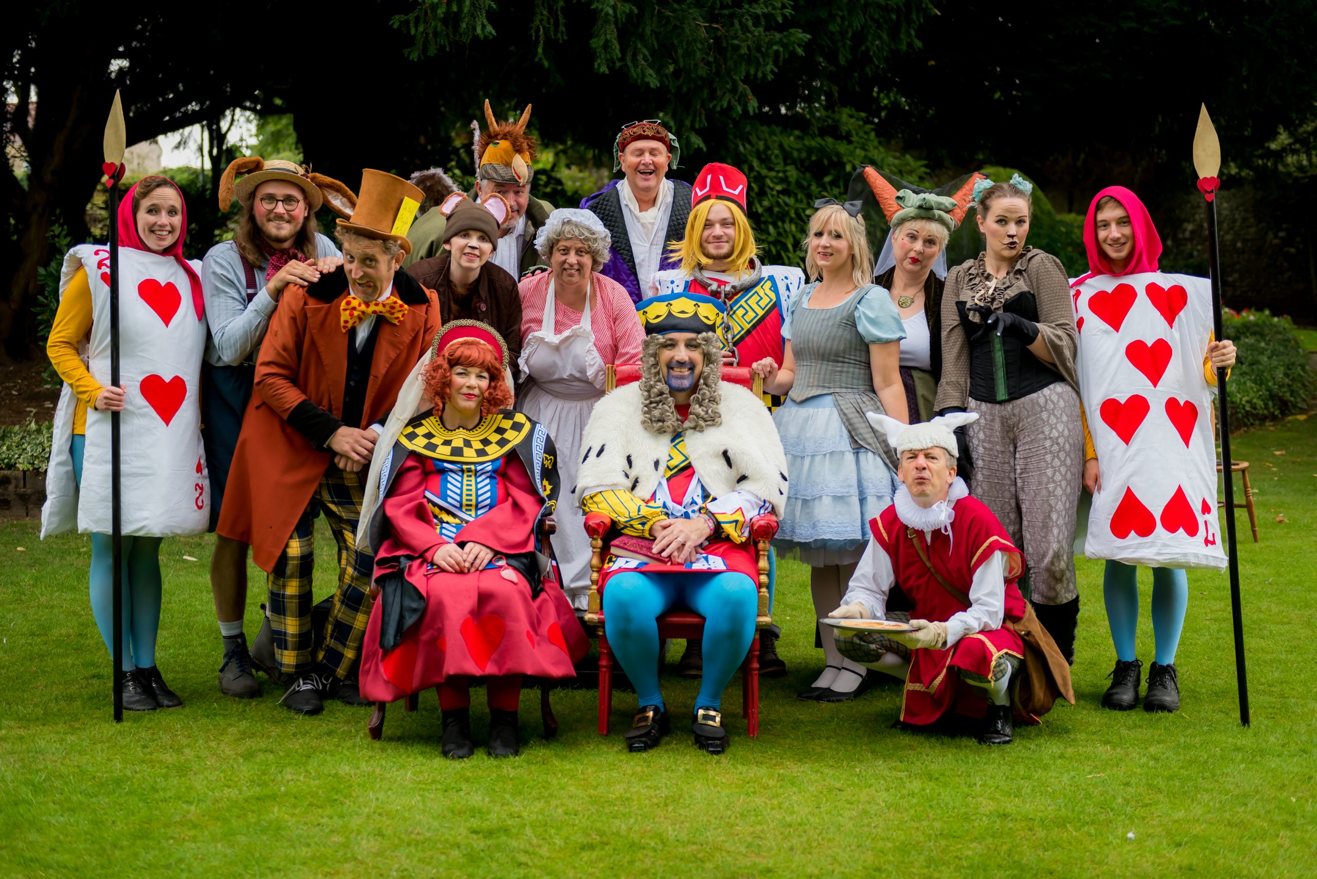 The cast of Alice in Wonderland with King's Gardens Thetford as the backdrop