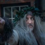 Ghost of Christmas Present, with long grey hair and a headband made of holly, A Christmas Carol