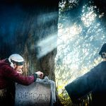 The ghost of Christmas Yet to Come stood in a graveyard surrounded by smoke pointing at Scrooge, A Christmas Carol