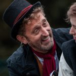 Fagin smiling at Oliver Twist